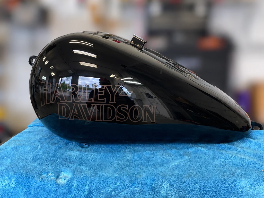 Black Harley-Davidson fuel tank after paintless dent repair