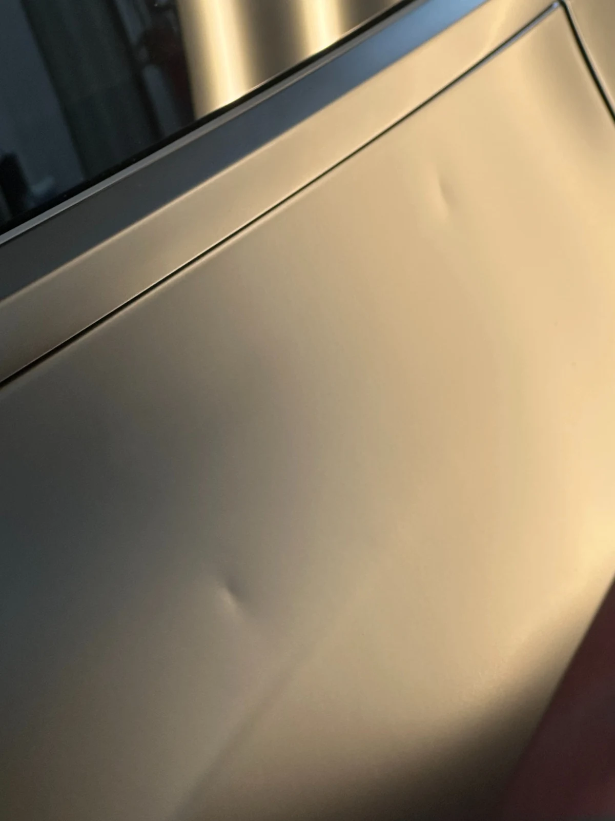 Hail dents on a wrapped Tesla panel at Pro Dent in Hoover